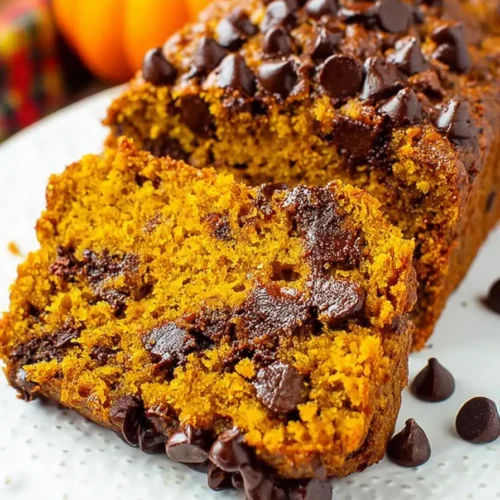 Moist chocolate chip pumpkin bread topped with melted chocolate chips and rich autumn flavors
