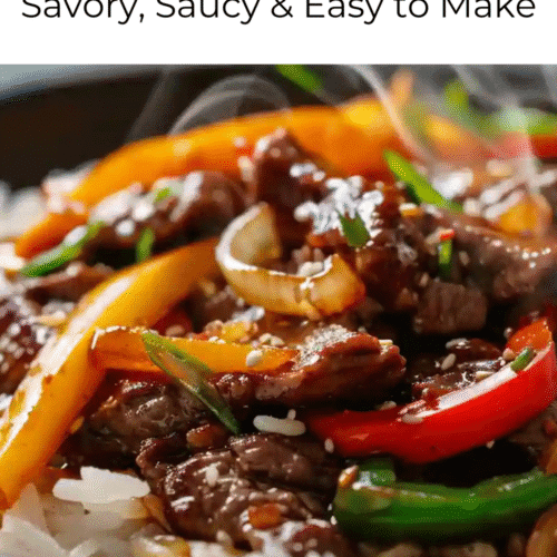 Close-up of pepper steak with bell peppers, onions, and sesame seeds served over white rice