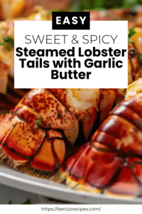 Close-up of garlic butter lobster tails garnished with parsley and lemon wedges on a white plate