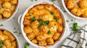 Overhead view of golden cheesy tater tot casserole baked to perfection, topped with melted cheese and parsley.