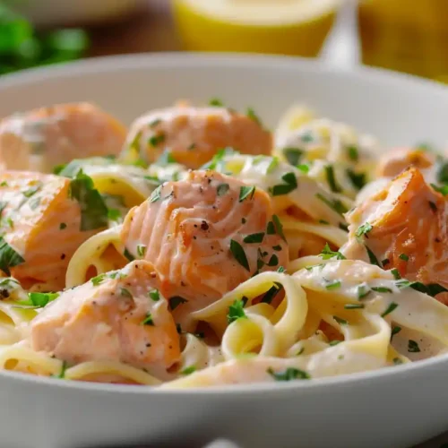 Bowl of creamy salmon pasta with lemon and herbs