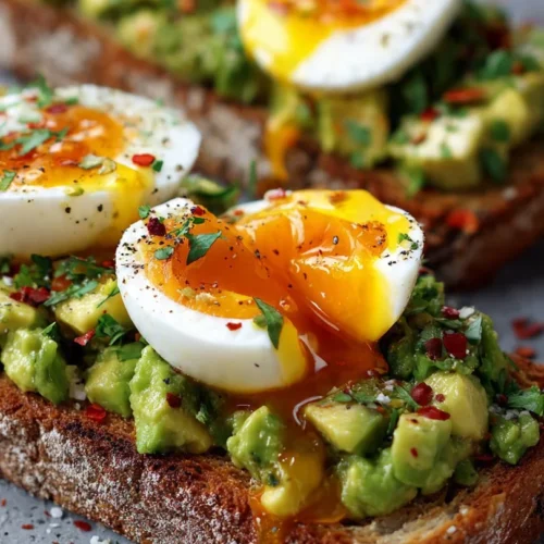 Avocado Egg Toast topped with a perfectly poached egg and herbs