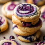 Blueberry cheesecake cookies with creamy topping and blueberry garnish