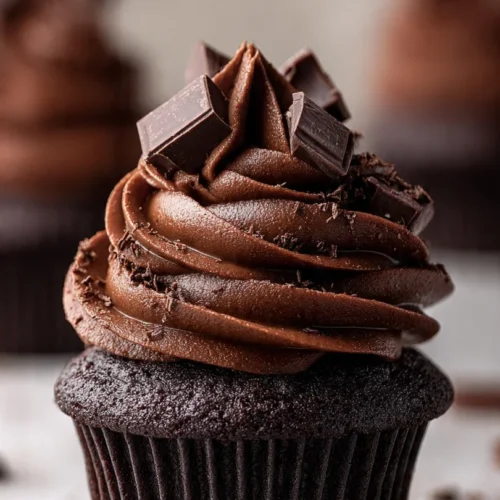 Delicious chocolate cheesecake bites topped with chocolate drizzle on a plate.