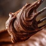 Delicious chocolate frosting topping a homemade cake