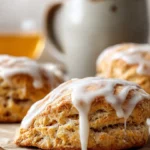 Delicious cinnamon bun scones with a cinnamon glaze on a plate