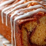 Delicious cinnamon roll banana bread with swirls of cinnamon and icing.