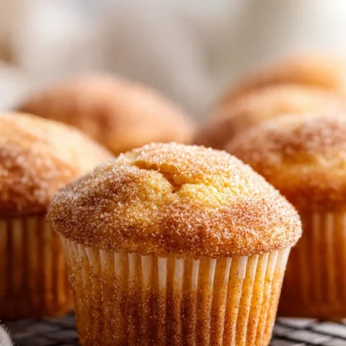 Freshly baked Cinnamon Sugar French Toast Muffins on a wooden table