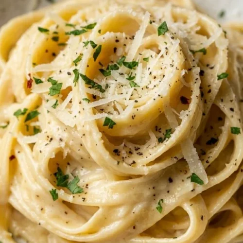 Creamy garlic parmesan pasta served in a bowl with a sprinkle of parmesan cheese