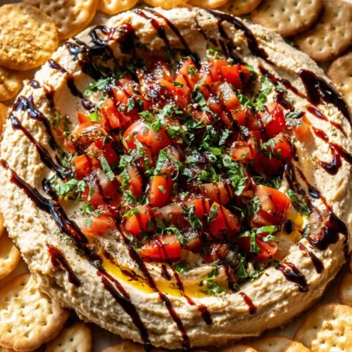 Plate of creamy herbed cheese garnished with fresh herbs
