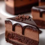 Delicious dark chocolate mousse cake topped with chocolate shavings and berries