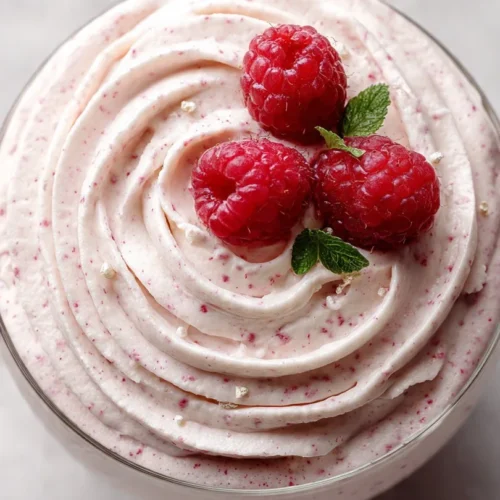 Delicious Fresh Raspberry Cloud Mousse topped with fresh raspberries and mint leaves