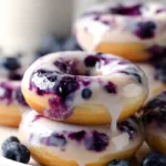 Gluten-free blueberry glazed donuts on a plate