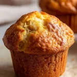 Delicious Greek Yogurt Banana Muffins on a plate topped with banana slices