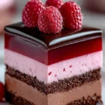 Heavenly Raspberry Chocolate Mousse Cake topped with fresh raspberries and chocolate shavings