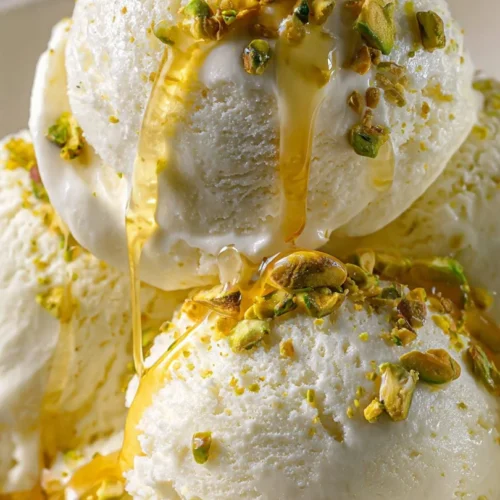 Creamy homemade Greek yogurt ice cream in a bowl, garnished with fresh fruits.