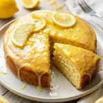 Delicious Lemon Chantilly Cake topped with whipped cream and fresh lemons.