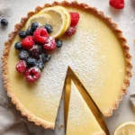 Delicious lemon tart with a golden crust and vibrant yellow filling.