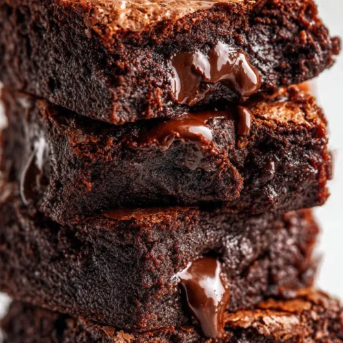 Delicious low calorie Greek yogurt brownies topped with chocolate drizzle.