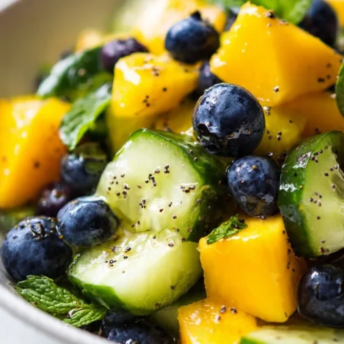 Mango Cucumber Salad featuring blueberries and avocado in a colorful bowl