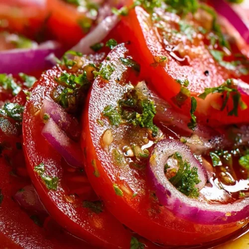 Bowl of marinated tomatoes with herbs and spices