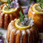Mini lemon cakes with a lavender glaze, beautifully presented on a plate.