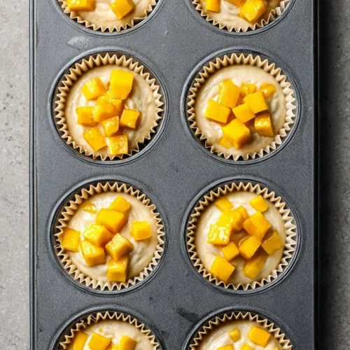 Deliciously baked peach cobbler muffins topped with fresh peaches
