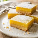 Delicious Pioneer Woman lemon bars freshly baked and garnished with powdered sugar