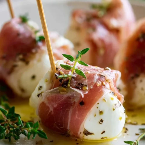 Delicious prosciutto wrapped mozzarella bites prepared as an appetizer