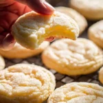Soft and chewy lemon cookies arranged on a plate, drizzled with lemon icing.