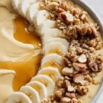 Delicious Sweet Potato Breakfast Bowl topped with nuts and fruits