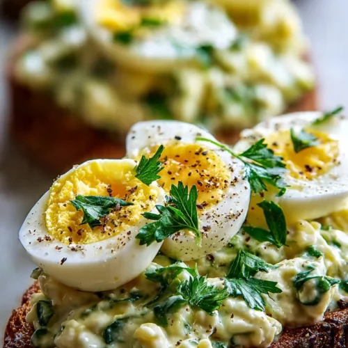 Zesty avocado egg salad in a bowl with fresh herbs and spices