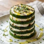 Layered zucchini and goat cheese stack recipe presented on a plate