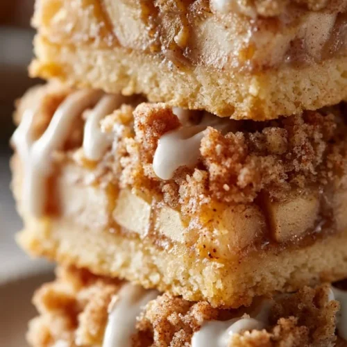 Delicious homemade apple bars, baked and ready to enjoy with cinnamon topping.