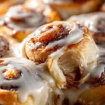 Delicious banana bread cinnamon rolls topped with creamy frosting.