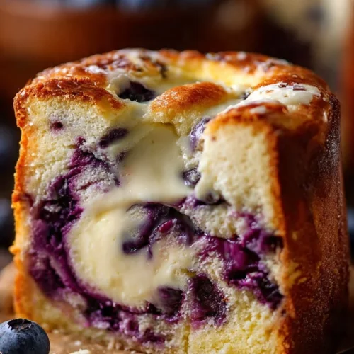 Delicious blueberry muffin cake topped with fresh blueberries and a golden crust