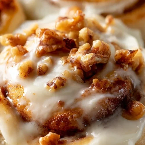 Homemade Carrot Cake Cinnamon Rolls topped with cream cheese frosting