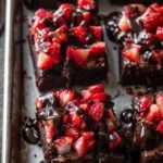 Delicious chocolate covered strawberry brownies displayed on a dessert table