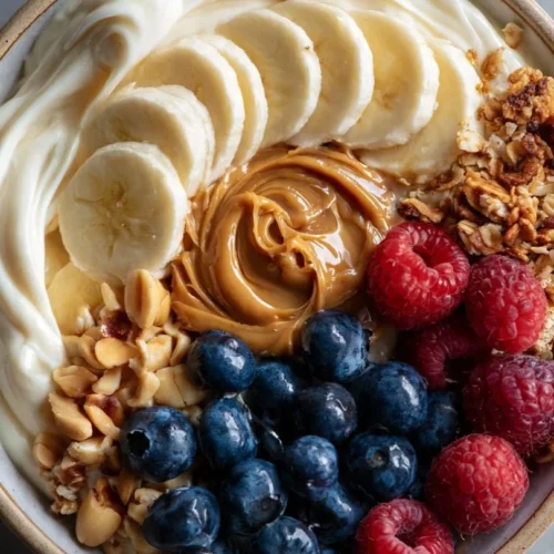 Delicious coconut yogurt bowl topped with fresh fruits and nuts