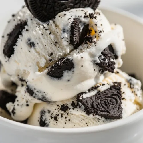 Delicious cookies and cream ice cream served in a bowl with chunks of cookies