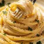 Cream cheese pasta topped with fresh herbs and seasonings