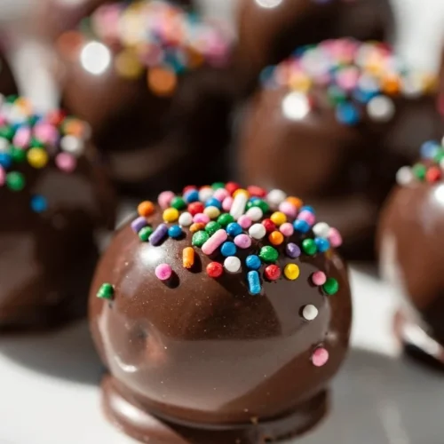 Delicious Easter Oreo Balls covered in chocolate on a decorative plate