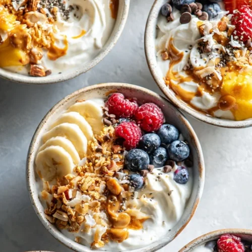 Colorful yogurt granola bowls topped with fruits and nuts for a healthy breakfast