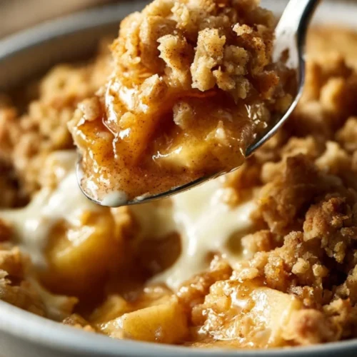 A bowl of healthy breakfast apple crumble topped with nuts and berries