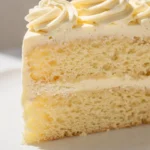 Homemade buttermilk cake with creamy buttercream frosting on a plate