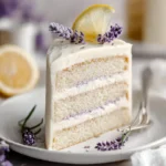 A beautifully decorated Lemon Lavender Cake with floral accents and lemon slices.