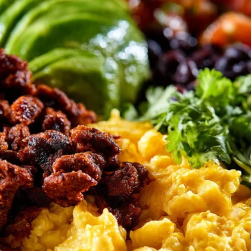 A vibrant Mexican breakfast bowl featuring eggs, avocado, and fresh toppings.
