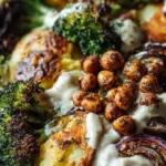 Roasted potato salad topped with BBQ chickpeas in a colorful bowl.