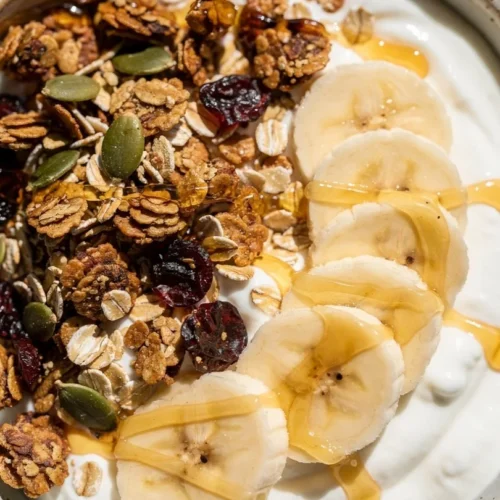Delicious salted caramel banana yogurt bowl topped with fresh bananas and caramel drizzle