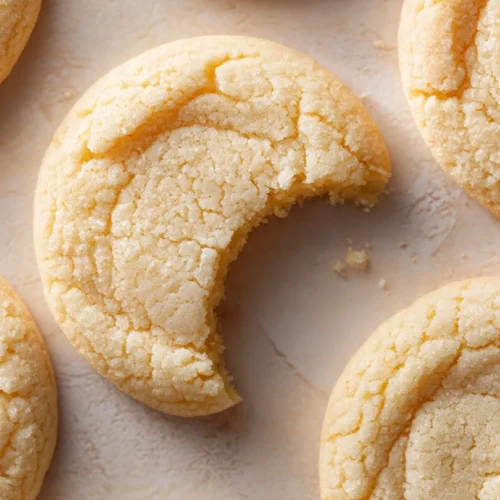 Soft and chewy sugar cookies on a white plate ready to enjoy